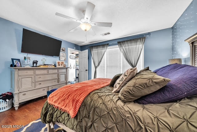 116 Newport Road Northeast Milledgeville, GA 31061 - Photo 20 of 30 a bedroom with a bed and a flat tv screen on dresser