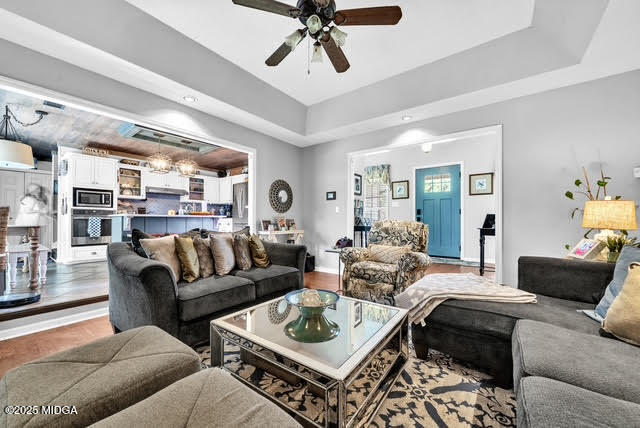 116 Newport Road Northeast Milledgeville, GA 31061 - Photo 9 of 30 a living room with furniture a rug potted plant and a large window