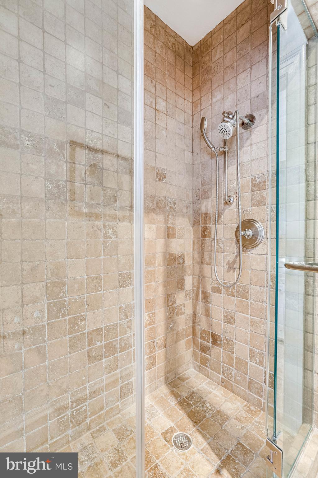 1514 17th Street Northwest, Unit 107 Washington, DC 20036 - Photo 26 of 63 Tiled shower with glass enclosure