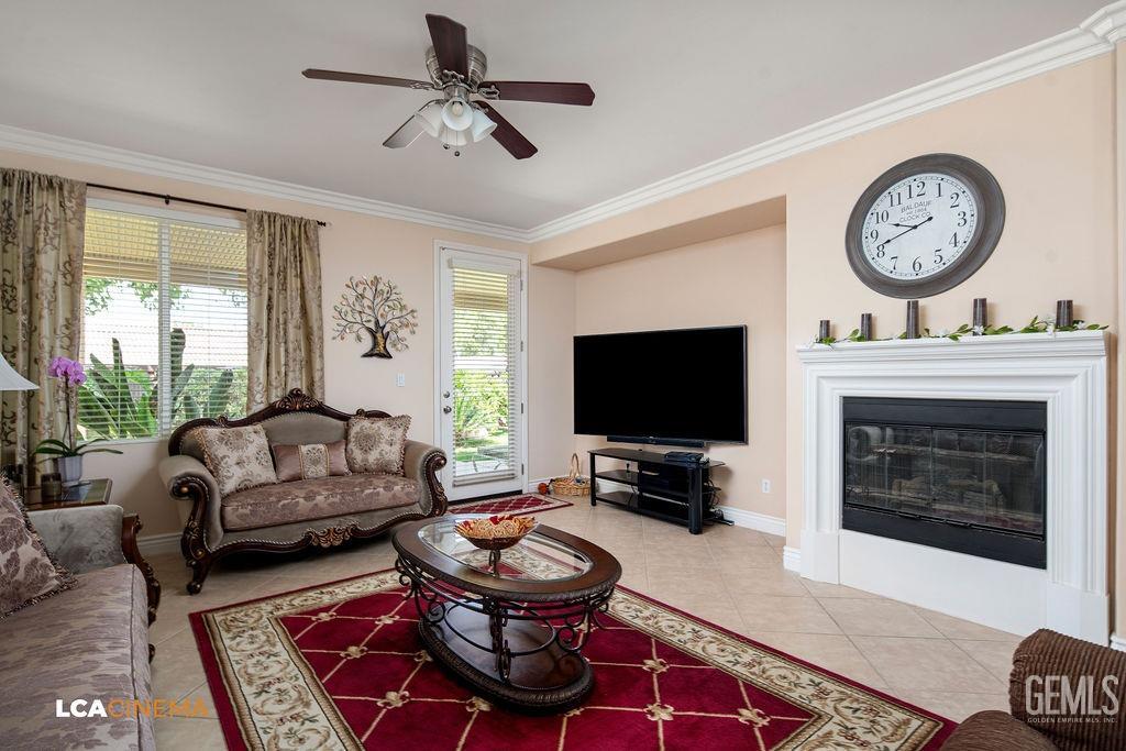 Undisclosed Address Bakersfield, CA 93306 - Photo 13 of 51 a living room with furniture a flat screen tv and a fireplace