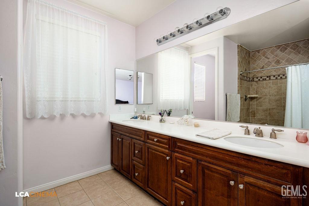 Undisclosed Address Bakersfield, CA 93306 - Photo 16 of 51 a bathroom with double sink and a mirror
