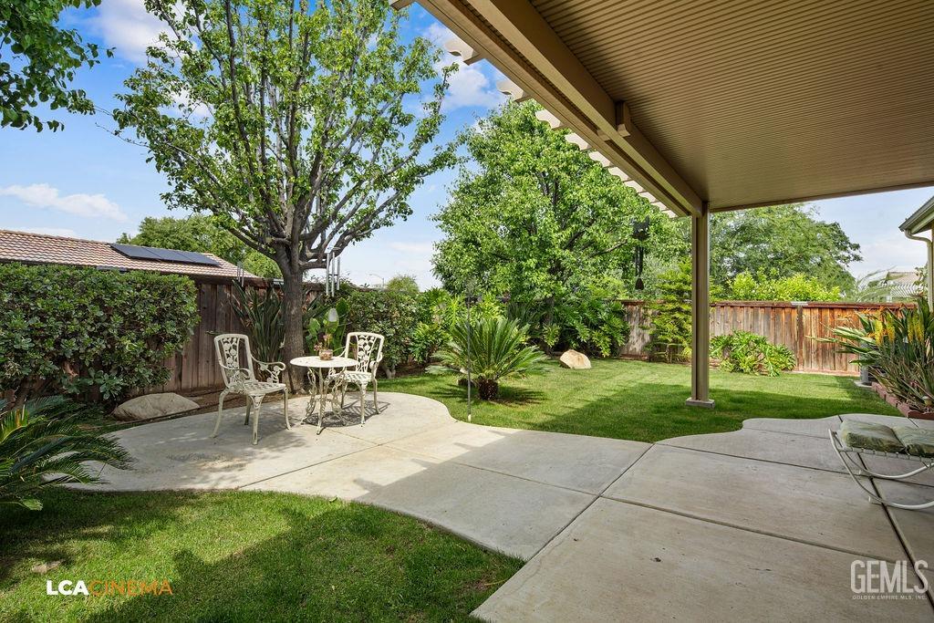 Undisclosed Address Bakersfield, CA 93306 - Photo 21 of 51 a view of a chair and table in backyard of the house