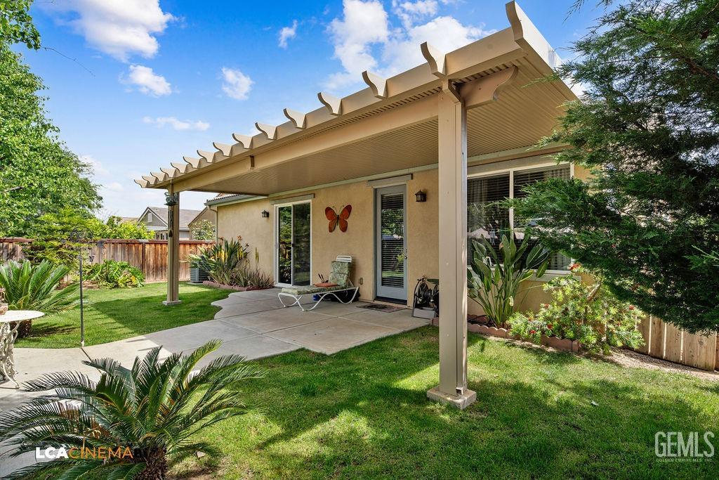 Undisclosed Address Bakersfield, CA 93306 - Photo 23 of 51 a view of a chair and table in backyard of the house
