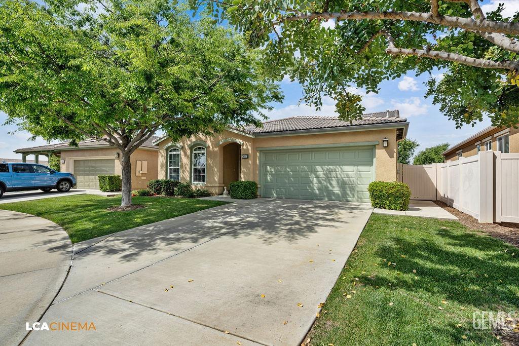 Undisclosed Address Bakersfield, CA 93306 - Photo 25 of 51 a front view of a house with a garden