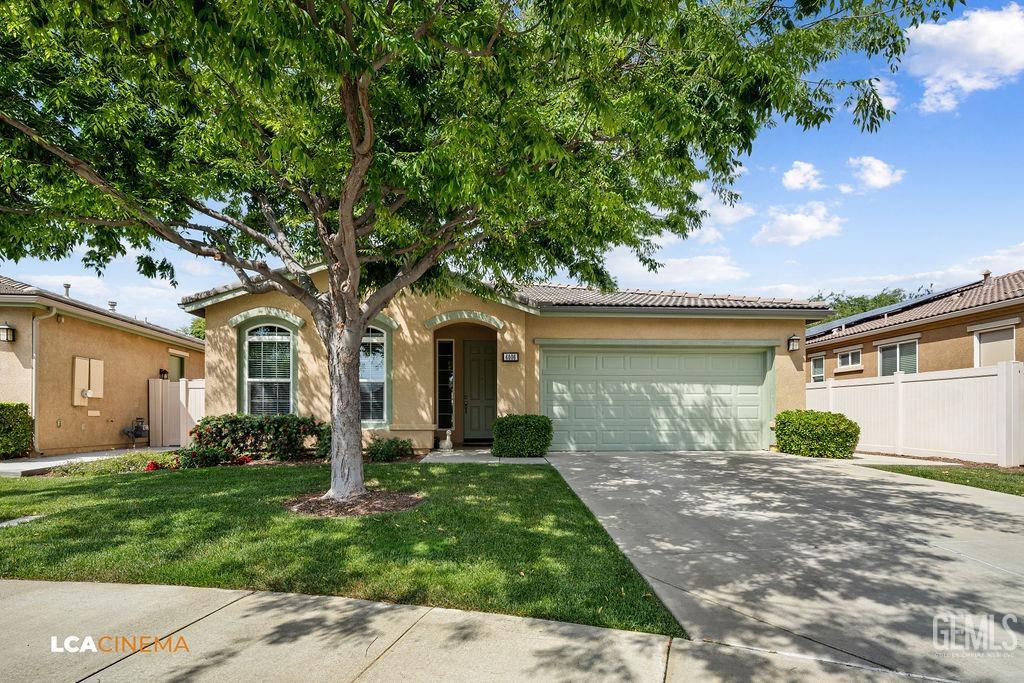 Undisclosed Address Bakersfield, CA 93306 - Photo 26 of 51 a front view of a house with a garden and yard