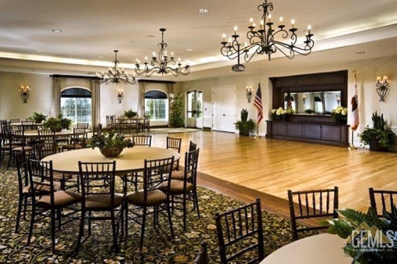 Undisclosed Address Bakersfield, CA 93306 - Photo 46 of 51 a view of a dining room with furniture a chandelier and wooden floor