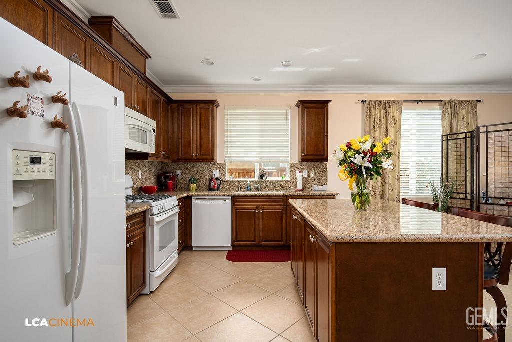 Undisclosed Address Bakersfield, CA 93306 - Photo 8 of 51 a kitchen with stainless steel appliances granite countertop a sink stove and refrigerator