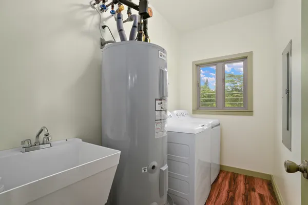 a bathroom with a sink and mirror with bathtub