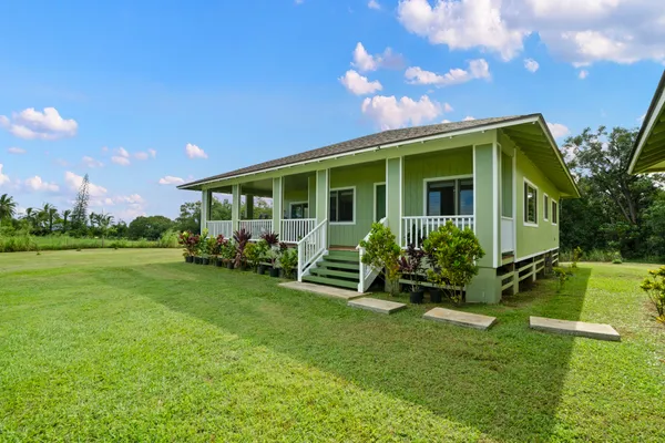 a front view of a house with garden