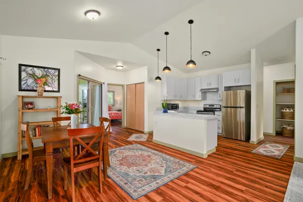 a living room with dining room and wooden floor