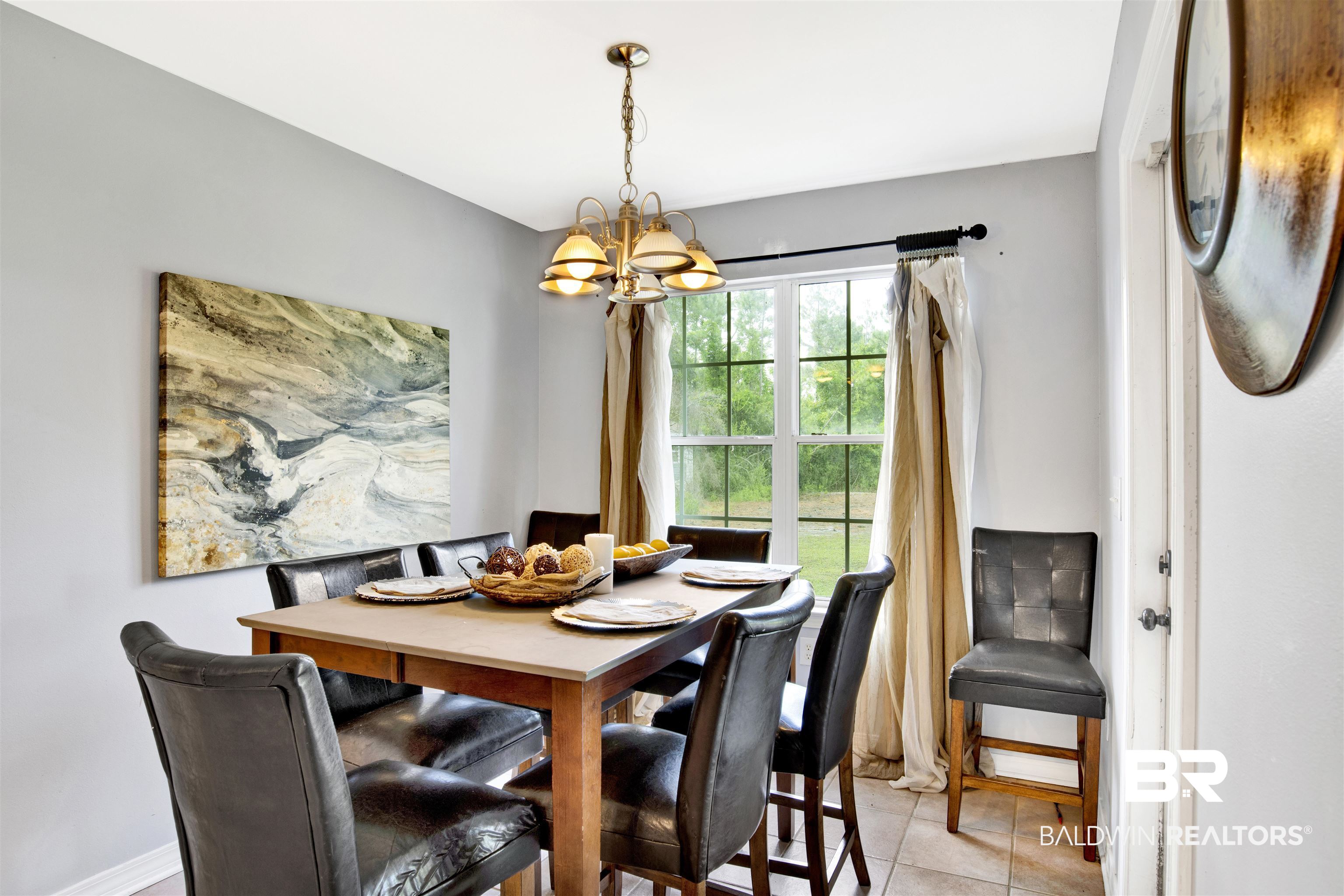 24384 Sailfish Lane Orange Beach, AL 36561 - Photo 9 of 23 Tiled dining area featuring a notable chandelier