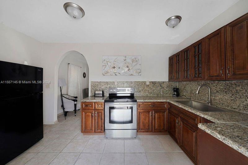a kitchen with a stove top oven cabinets a counter space and stainless steel appliances