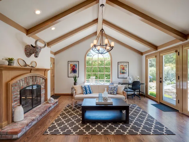 a living room with furniture fireplace and window