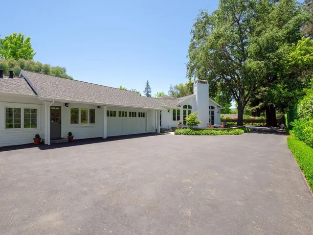 a view of a house with a garden and pathway