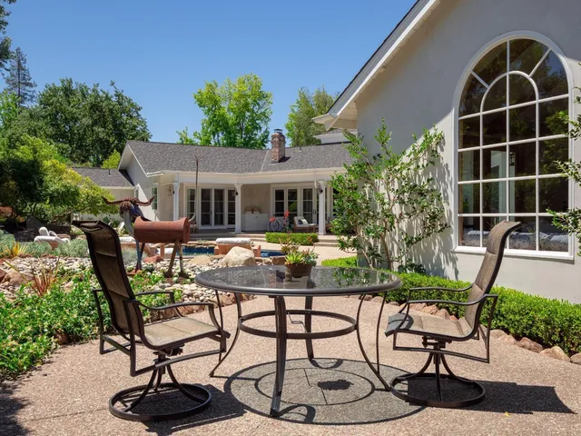 a view of a chair and table in the patio