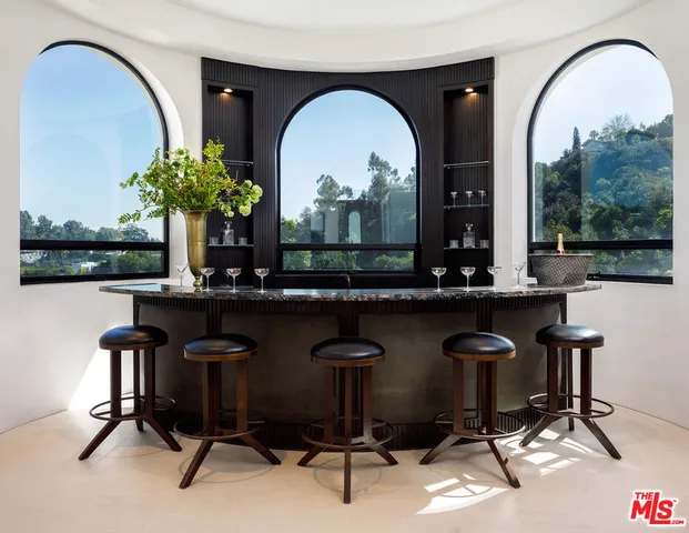 a kitchen with a table chairs and a kitchen view
