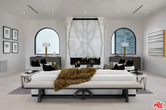 a living room with furniture and a large mirror