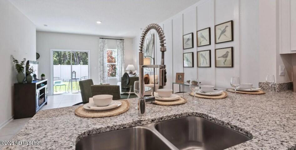 67 Blue Hvn Road St. Augustine, FL 32095 - Photo 2 of 24 a kitchen with a granite countertop sink and a stove