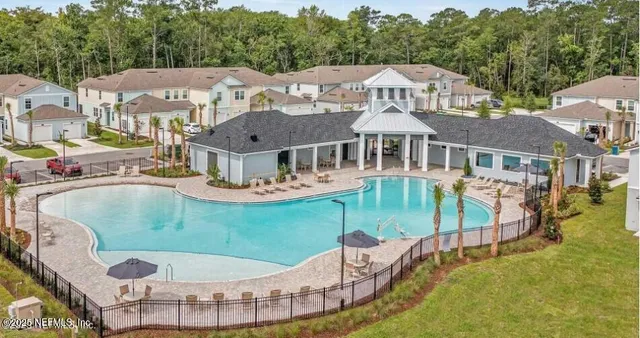 an aerial view of a house with swimming pool garden and patio
