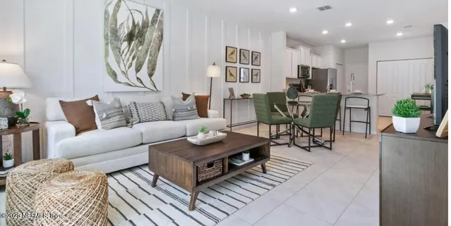 a living room with furniture and a potted plant