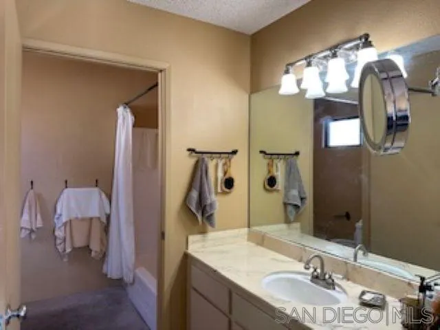 2258 Caminito Pescado, Unit 11 San Diego, CA 92107 - Photo 4 of 13 a bathroom with a sink and a mirror