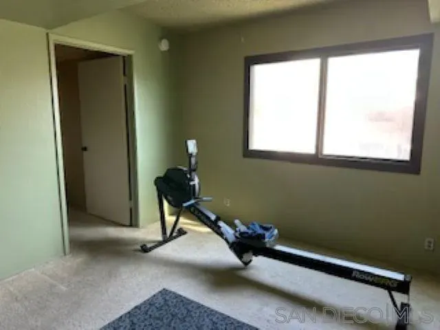 a bench sitting in a bedroom next to a window