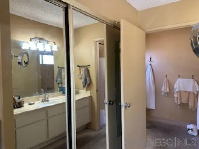 2258 Caminito Pescado, Unit 11 San Diego, CA 92107 - Photo 9 of 13 a bathroom with a double vanity sink mirror and shower
