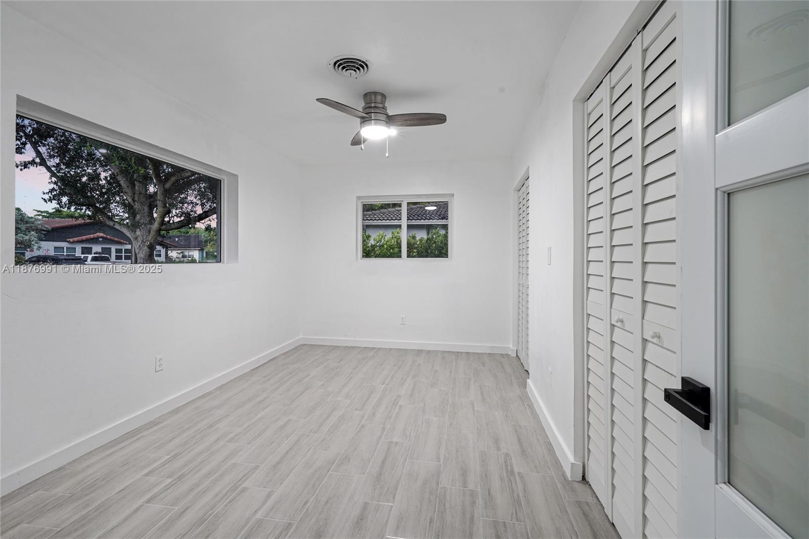 7516 Northwest 44th Court, Unit B Coral Springs, FL 33065 - Photo 13 of 26 wooden floor in an empty room with a window