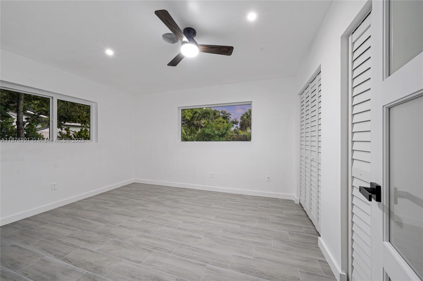 7516 Northwest 44th Court, Unit B Coral Springs, FL 33065 - Photo 16 of 26 wooden floor in an empty room with a window