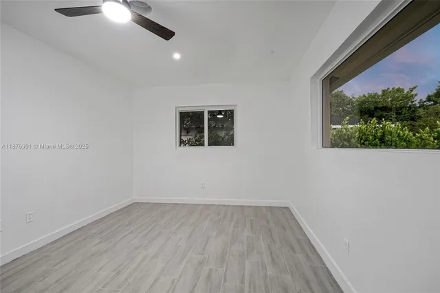 an empty room with wooden floor and closet