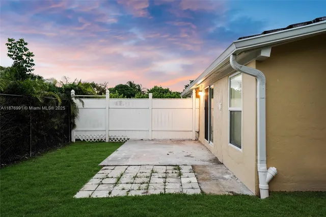 a backyard of a house with lots of green space and garden