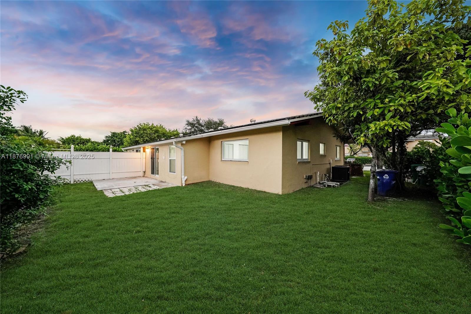 7516 Northwest 44th Court, Unit B Coral Springs, FL 33065 - Photo 22 of 26 a backyard of a house with lots of green space and garden