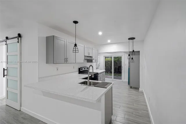 a kitchen with stainless steel appliances a refrigerator sink and cabinets