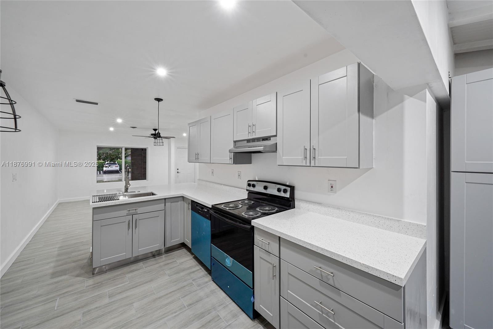 7516 Northwest 44th Court, Unit B Coral Springs, FL 33065 - Photo 8 of 26 a kitchen with granite countertop a sink a stove and refrigerator