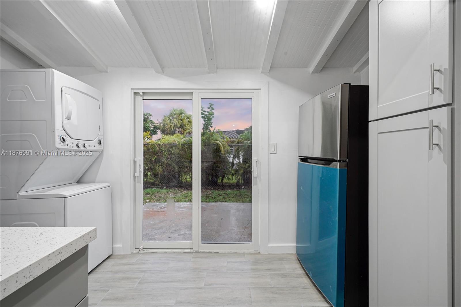 7516 Northwest 44th Court, Unit B Coral Springs, FL 33065 - Photo 9 of 26 a view of a kitchen with a sink refrigerator and wooden floor