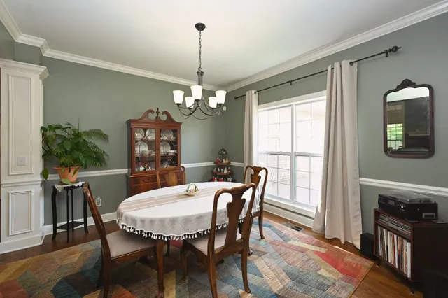 a kitchen with granite countertop a sink a stove and cabinets