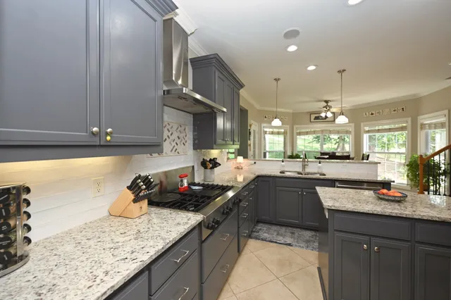 a kitchen with granite countertop cabinets and oven