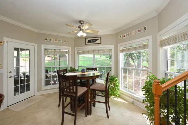 a dining room with furniture a rug and a large window