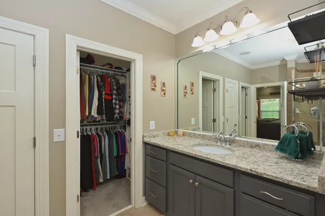 a view of walk in closet with clothes and shoes