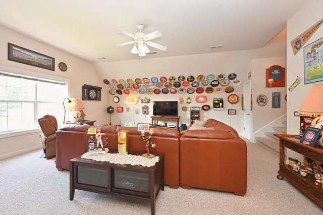 a living room with furniture and a floor to ceiling window