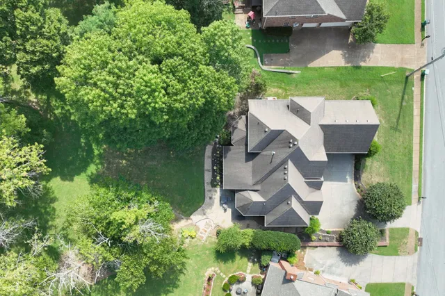 a living room with furniture a fireplace and a large window