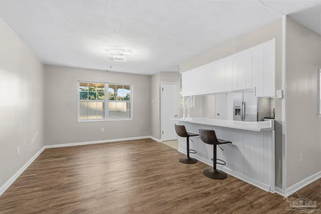 a view of an empty room with a fireplace and a window