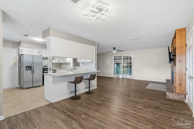 a kitchen with granite countertop a sink and cabinets