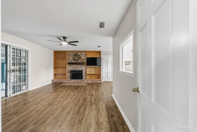 wooden floor in an empty room with a fireplace