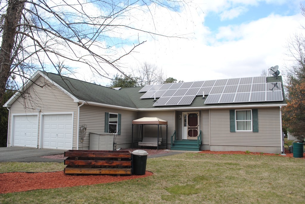 207 Turnpike Road Montague, MA 01376 - Photo 1 of 22 a front view of a house with a garden