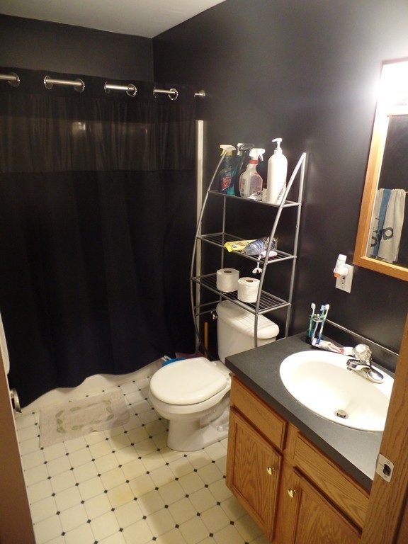207 Turnpike Road Montague, MA 01376 - Photo 4 of 22 a bathroom with a sink toilet mirror and vanity