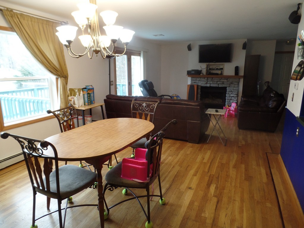 207 Turnpike Road Montague, MA 01376 - Photo 9 of 22 a view of a dining room with furniture a chandelier and wooden floor