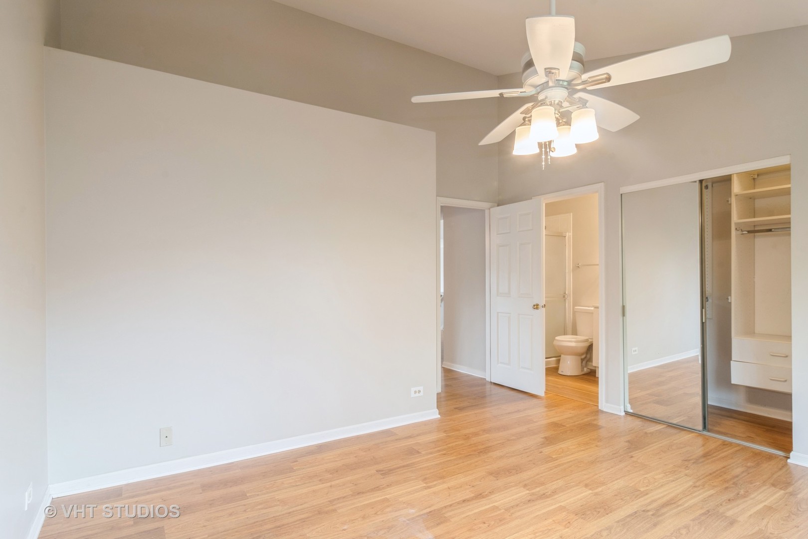 8223 Ripple Ridge Darien, IL 60561 - Photo 8 of 17 an empty room with wooden floor chandelier fan and closet area