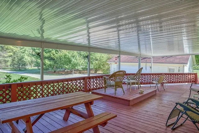 a view of a wooden deck with furniture