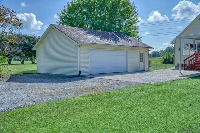 a view of a house with a yard and garage